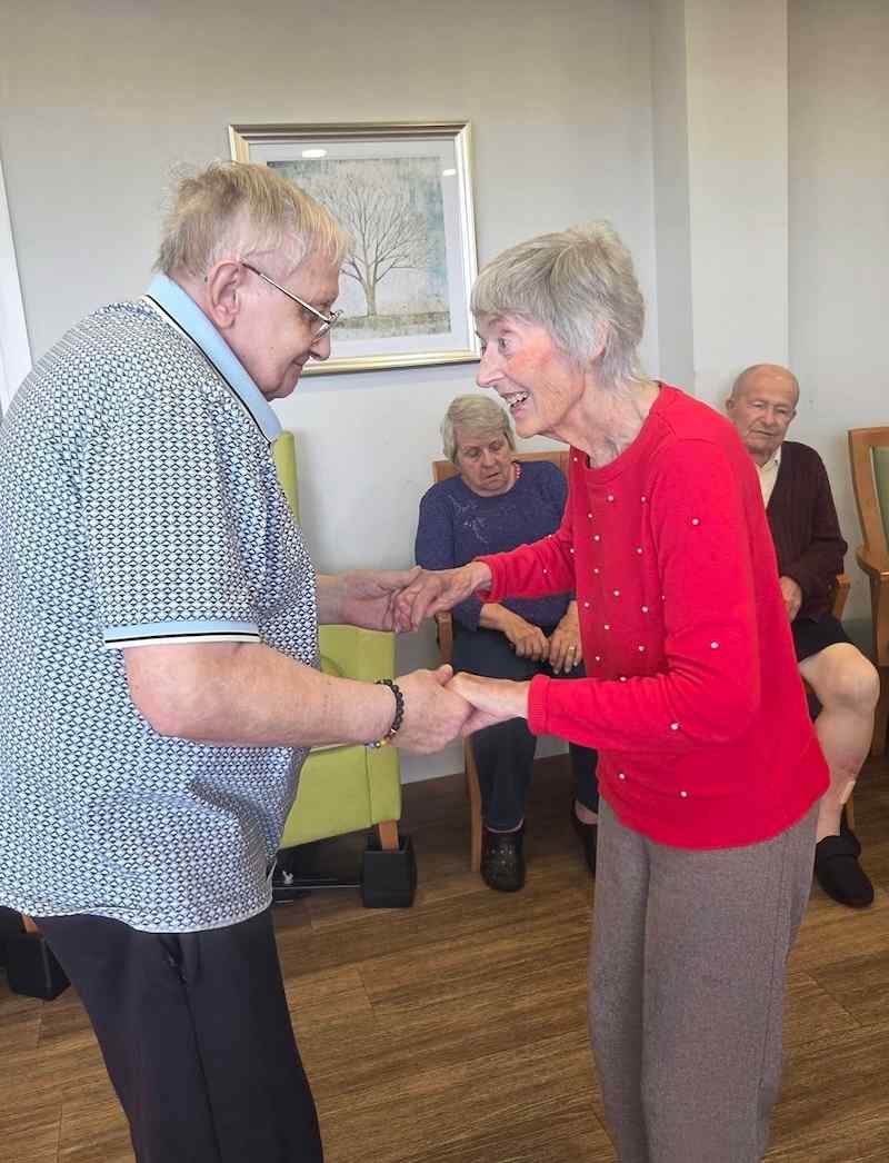 2 of our residents stood in the lounge together dancing